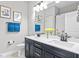 Well-lit bathroom with double vanity, quartz countertop, modern fixtures and a tub shower at 34266 Radley Way, Wesley Chapel, FL 33545