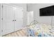 Well-lit bedroom featuring a closet with double doors, adjacent to a doorway to another room at 34266 Radley Way, Wesley Chapel, FL 33545