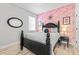 Stylish bedroom features flamingo wallpaper, modern decor, a comfortable bed, and a serene atmosphere at 34266 Radley Way, Wesley Chapel, FL 33545