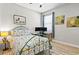 Bright bedroom featuring a twin-monitor workstation and eye-catching art, offers a comfortable and functional space at 34266 Radley Way, Wesley Chapel, FL 33545