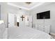 Bright bedroom featuring a tray ceiling, neutral tones, and an en-suite bathroom access at 34266 Radley Way, Wesley Chapel, FL 33545