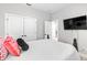 Bedroom featuring a large window, closet with double doors, and a tv for entertainment and relaxation at 34266 Radley Way, Wesley Chapel, FL 33545