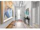 Bright hallway with hardwood floors, bench, and a decorative light fixture at 34266 Radley Way, Wesley Chapel, FL 33545