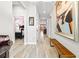 Bright hallway with hardwood floors and a large framed picture and furniture at 34266 Radley Way, Wesley Chapel, FL 33545