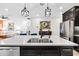 Spacious kitchen island featuring stainless steel sink, modern faucet, quartz countertop and stylish pendant lighting at 34266 Radley Way, Wesley Chapel, FL 33545