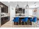 Modern kitchen with dark cabinets, a center island, pendant lighting and bar stool seating at 34266 Radley Way, Wesley Chapel, FL 33545
