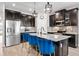 Modern kitchen with dark cabinets, stainless steel appliances, and a center island with bar stool seating at 34266 Radley Way, Wesley Chapel, FL 33545
