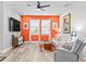 Bright living room with an accent wall, modern furniture, and windows that let in ample natural light at 34266 Radley Way, Wesley Chapel, FL 33545