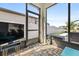 Cozy screened patio featuring tile flooring, a television, and a backyard pool view at 34266 Radley Way, Wesley Chapel, FL 33545