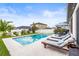 Relaxing pool area with lounge chairs, and green grass in a well maintained backyard at 34266 Radley Way, Wesley Chapel, FL 33545