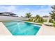 Beautiful backyard pool and lounge chairs with white picket fence at 34266 Radley Way, Wesley Chapel, FL 33545