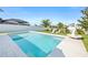 Clean, refreshing pool surrounded by lush lawn and a manicured, white-fenced yard at 34266 Radley Way, Wesley Chapel, FL 33545