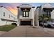 Charming two-story home featuring a dark two-car garage, complemented by a well-manicured lawn and a palm tree at 3605 Bay Heights Way, Tampa, FL 33611