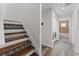 Hallway with decorative stairs leading to the second floor and the laundry room at 3605 Bay Heights Way, Tampa, FL 33611