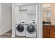 Modern laundry room featuring newer front-load washer and dryer at 3605 Bay Heights Way, Tampa, FL 33611