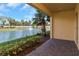 View from patio towards lake with fountain and lush landscaping, inviting outdoor space at 4139 Rocky Shores Dr, Tampa, FL 33634