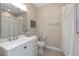 Bright bathroom features a shower, neutral walls, a stylish basket, and a white granite countertop at 4139 Rocky Shores Dr, Tampa, FL 33634