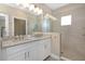Modern bathroom featuring double sinks, granite countertops, and a glass-enclosed shower at 4139 Rocky Shores Dr, Tampa, FL 33634