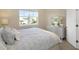 Bedroom with wood floors, dresser with mirror and a large window providing natural light at 4139 Rocky Shores Dr, Tampa, FL 33634