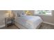 Comfortable bedroom features wood floors, mirrored nightstand, and an abundance of natural light at 4139 Rocky Shores Dr, Tampa, FL 33634