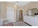 Bright bedroom features a crib, accent rug, lots of sunlight from the large window, and neutral walls at 4139 Rocky Shores Dr, Tampa, FL 33634