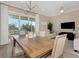 Dining room leading to a living area, with large windows showcasing outdoor scenery at 4139 Rocky Shores Dr, Tampa, FL 33634
