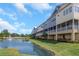 Exterior view of townhome complex with a scenic lakeside location and fountain at 4139 Rocky Shores Dr, Tampa, FL 33634