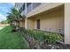 Landscaped area with view of building exterior, complemented by tropical foliage and well-maintained grounds at 4139 Rocky Shores Dr, Tampa, FL 33634