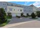 Townhomes with varied colors offer garages, tasteful landscaping and brick paver driveways under a blue sky at 4139 Rocky Shores Dr, Tampa, FL 33634