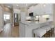 Bright kitchen with white cabinets, granite countertops, and seating at the island bar area at 4139 Rocky Shores Dr, Tampa, FL 33634