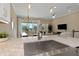 The kitchen sink features granite countertops, stainless steel appliances and a view into the living area at 4139 Rocky Shores Dr, Tampa, FL 33634