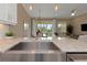 The stainless steel kitchen sink features granite countertops and a view into the living area at 4139 Rocky Shores Dr, Tampa, FL 33634