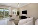 Cozy living room with access to a scenic balcony, offering views of lush greenery and outdoor space at 4139 Rocky Shores Dr, Tampa, FL 33634