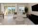 Bright living room with dining area, sofa, and balcony with sliding glass doors at 4139 Rocky Shores Dr, Tampa, FL 33634