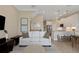 Open concept living room with kitchen, dining area, neutral color palette and hardwood floors at 4139 Rocky Shores Dr, Tampa, FL 33634
