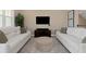 Comfortable living room featuring plush sofas, neutral decor, and a large TV for entertainment at 4139 Rocky Shores Dr, Tampa, FL 33634