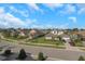 Scenic view of houses featuring manicured lawns, complemented by palm trees, blue skies, and fluffy white clouds at 4139 Rocky Shores Dr, Tampa, FL 33634