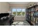 A well-lit office space with a bookshelf and multiple computer monitors at 4139 Rocky Shores Dr, Tampa, FL 33634