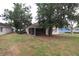 Spacious backyard featuring lush grass and a screened lanai for outdoor living at 4214 Longfellow Dr, Plant City, FL 33566