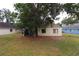 Well-maintained backyard with mature trees, providing a serene outdoor space at 4214 Longfellow Dr, Plant City, FL 33566
