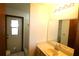 Well-lit bathroom featuring a cream vanity, large mirror and tiled floors at 4214 Longfellow Dr, Plant City, FL 33566