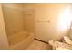A clean and well-maintained bathroom with tiled floors and a bathtub at 4214 Longfellow Dr, Plant City, FL 33566