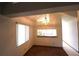 View of a dining room with a large window, unique light fixture, and a view to the kitchen at 4214 Longfellow Dr, Plant City, FL 33566
