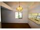 View of a dining room with a large window, unique light fixture, and a view to the kitchen at 4214 Longfellow Dr, Plant City, FL 33566