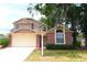 Charming two-story home features a brick facade and a two-car garage with lush front lawn at 4214 Longfellow Dr, Plant City, FL 33566