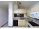 Bright kitchen with white appliances, tile floors, laminate countertops, and ample cabinet space at 4214 Longfellow Dr, Plant City, FL 33566