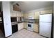 Bright kitchen with white appliances, tile floors, laminate countertops, and ample cabinet space at 4214 Longfellow Dr, Plant City, FL 33566