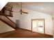 Spacious living room with high ceilings, a ceiling fan, a staircase, and glass doors to the yard at 4214 Longfellow Dr, Plant City, FL 33566