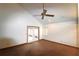 Spacious living room with high ceilings, a ceiling fan, and glass doors to the yard at 4214 Longfellow Dr, Plant City, FL 33566