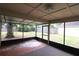 Enclosed back porch overlooking the backyard, perfect for outdoor lounging at 4214 Longfellow Dr, Plant City, FL 33566